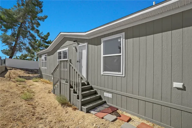 a view of a house with wooden fence