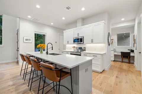 a kitchen with stainless steel appliances granite countertop a sink and cabinets