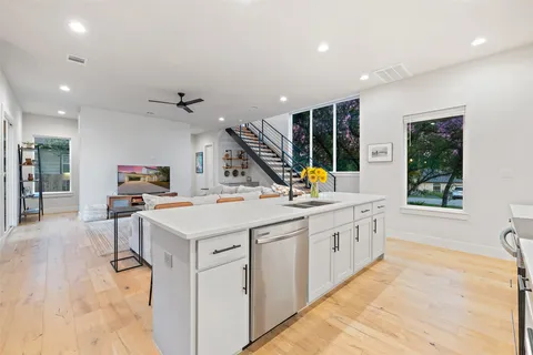 a large white kitchen with a large window
