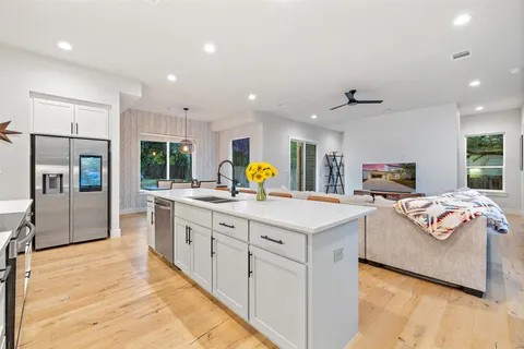 a kitchen with stainless steel appliances a refrigerator sink and microwave