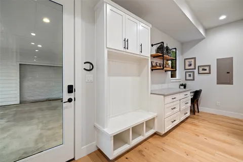 a bathroom with a tub sink vanity and mirror