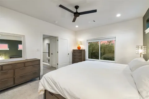 a spacious bedroom with a bed and a chandelier