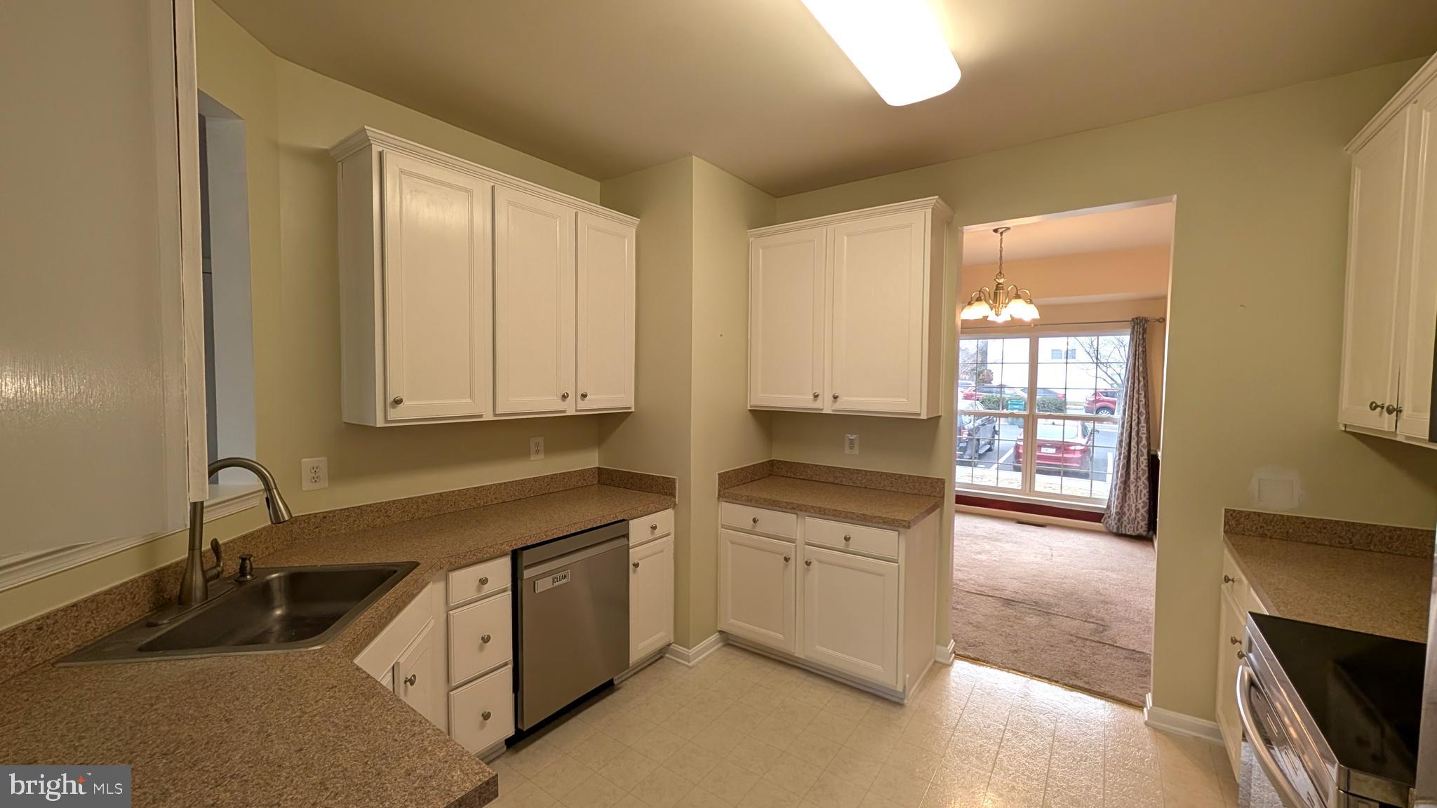 230 Whitman Lane Inwood, WV 25428 - Photo 11 of 29 a kitchen with granite countertop a sink a stove and cabinets