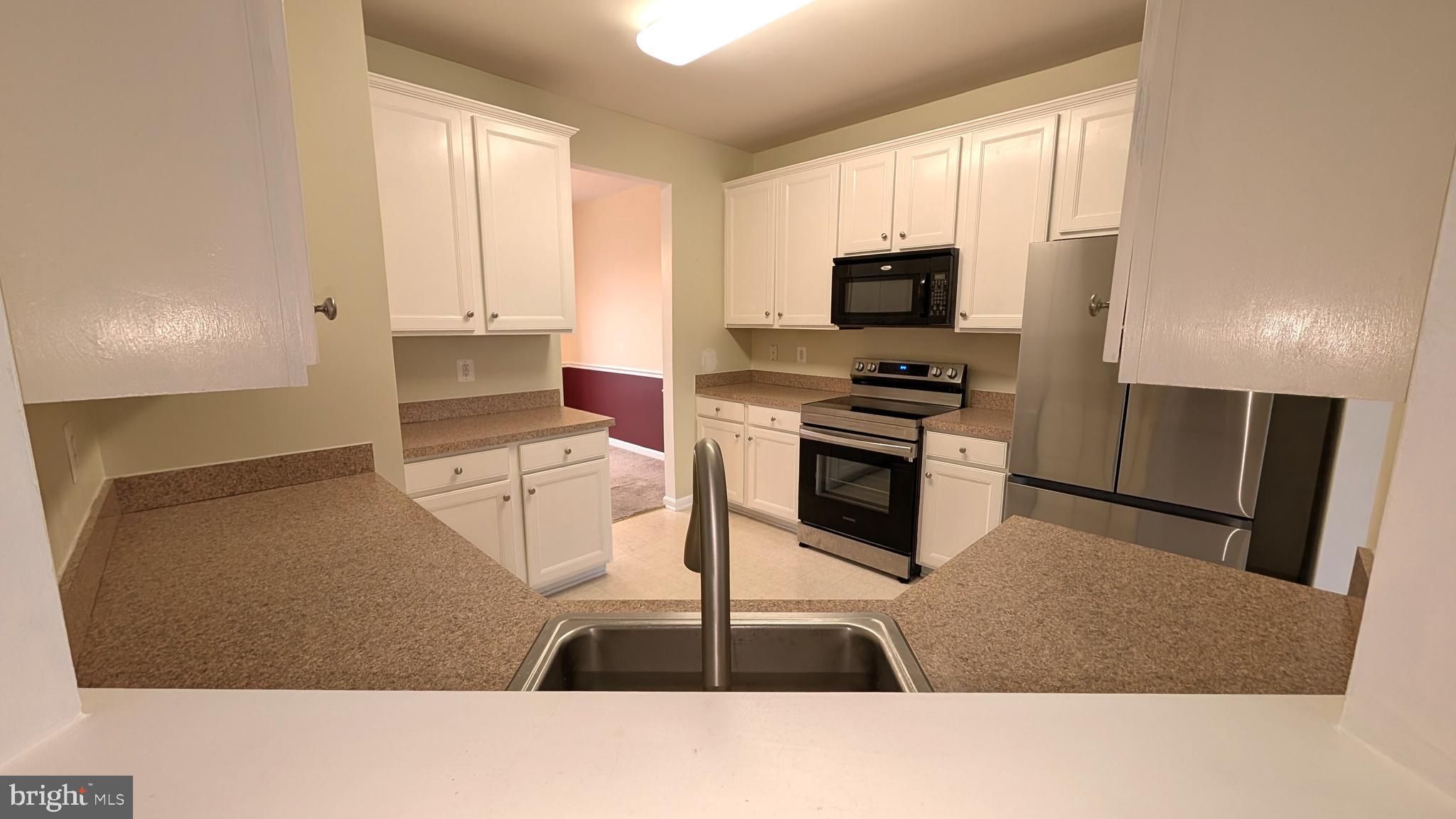 230 Whitman Lane Inwood, WV 25428 - Photo 12 of 29 a kitchen with granite countertop a stove and a refrigerator