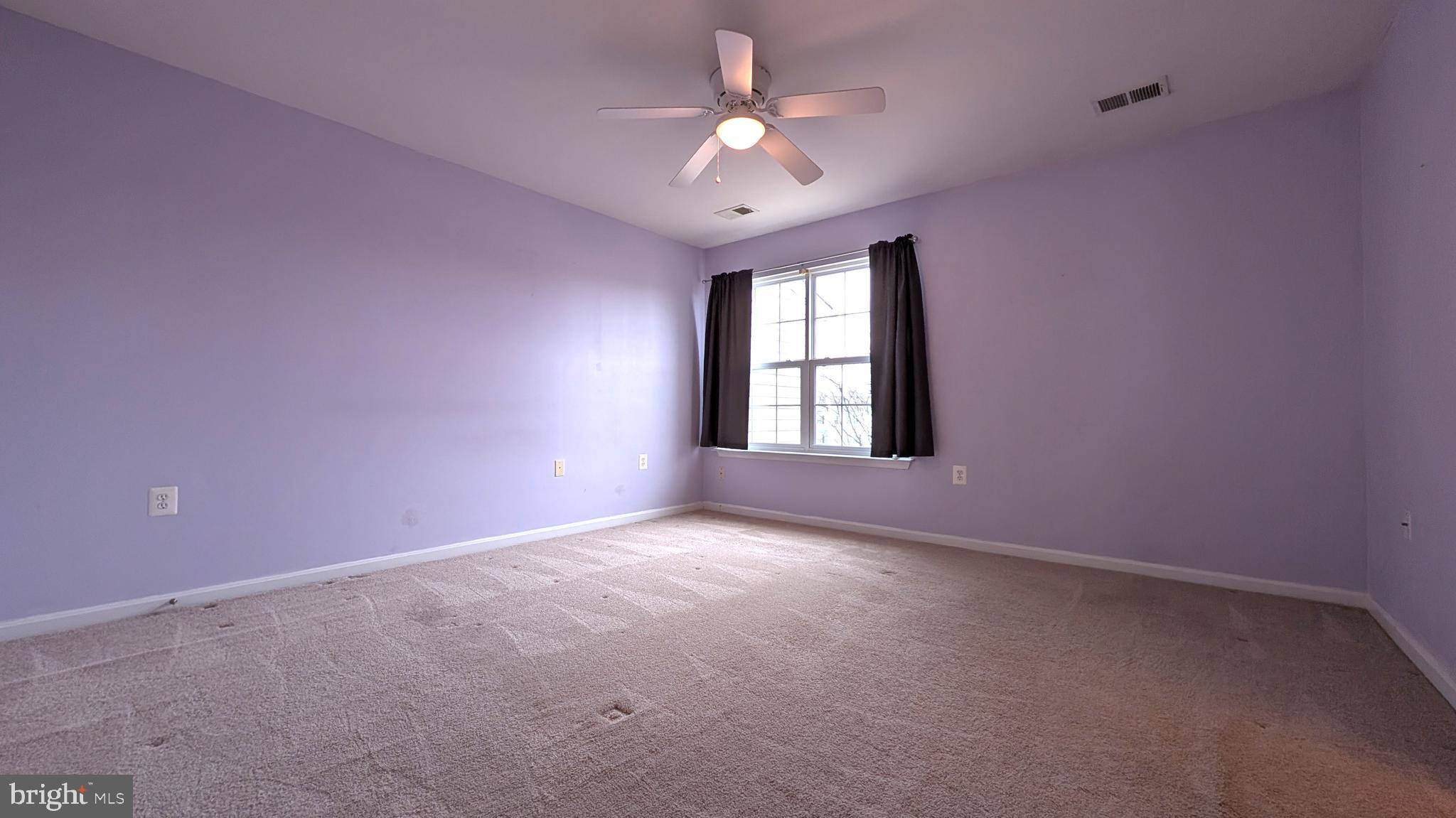 230 Whitman Lane Inwood, WV 25428 - Photo 14 of 29 a view of an empty room with a ceiling fan and window