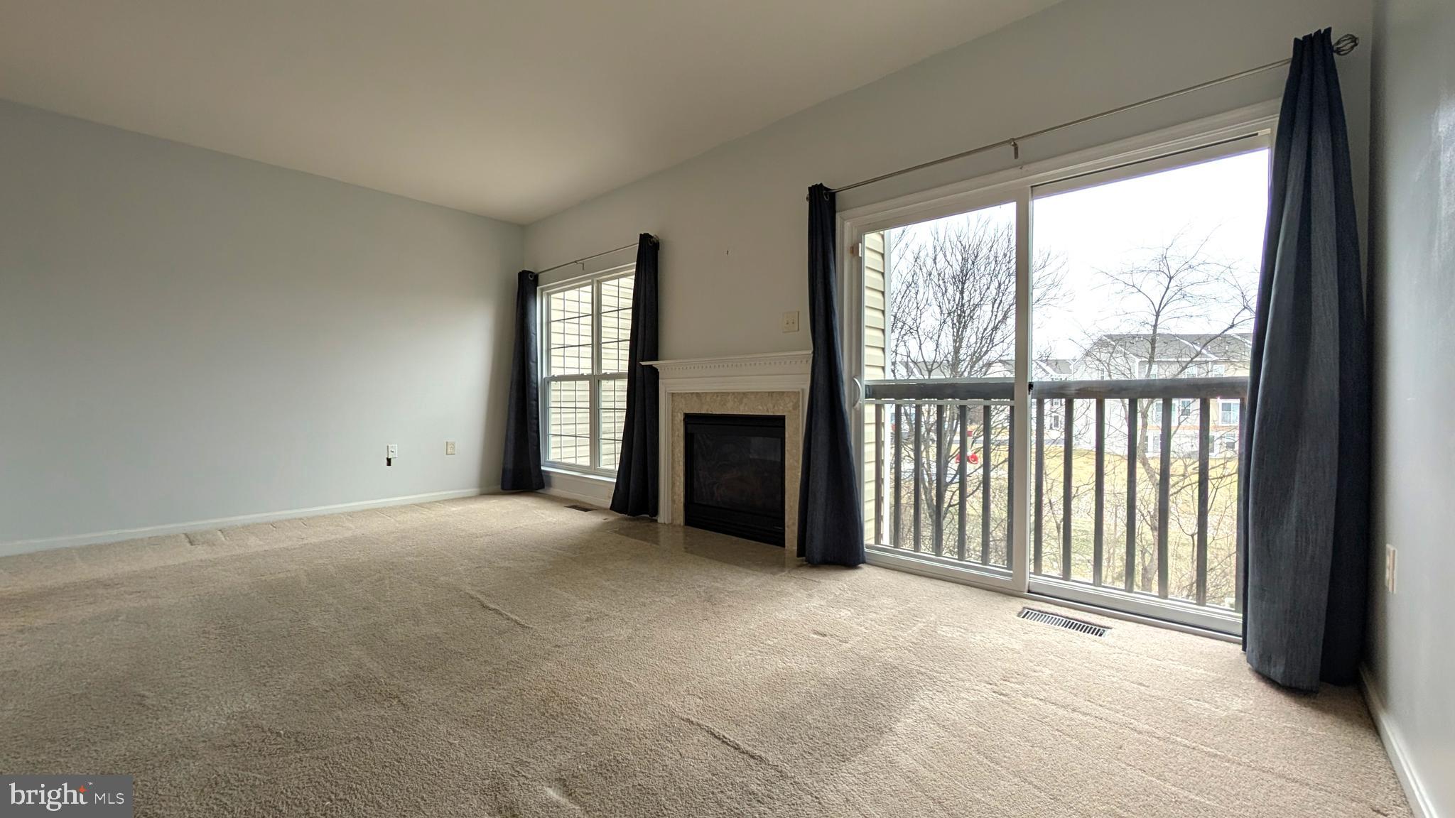 230 Whitman Lane Inwood, WV 25428 - Photo 7 of 29 a view of an empty room with a fireplace and a window