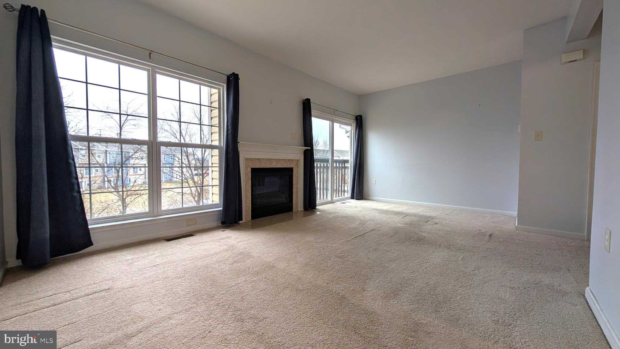 230 Whitman Lane Inwood, WV 25428 - Photo 8 of 29 an empty room with windows and fireplace