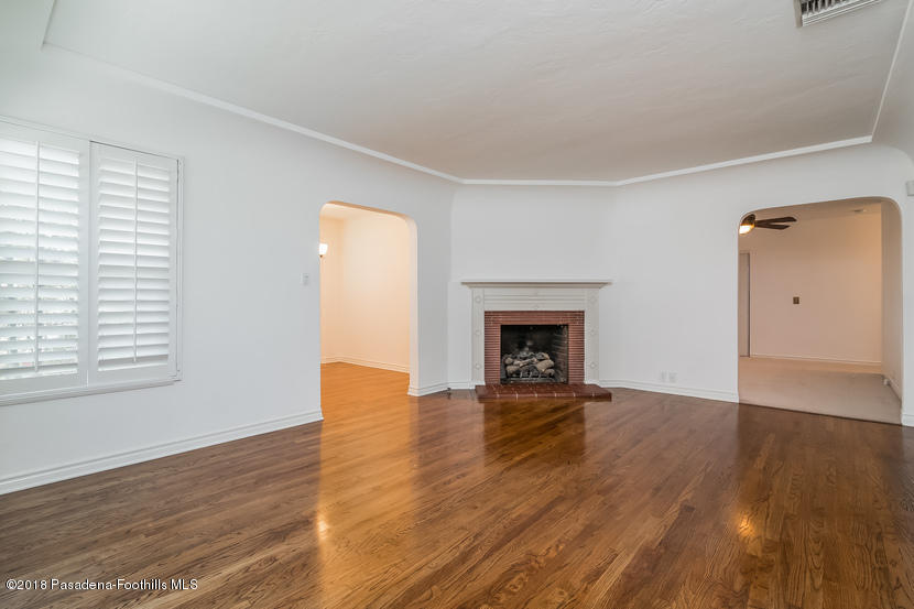 1771 North Altadena Drive Altadena, CA 91001 - Photo 2 of 29 an empty room with wooden floor and fireplace