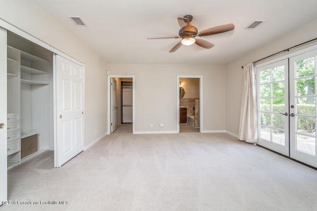 a view of a livingroom with a ceiling fan and window