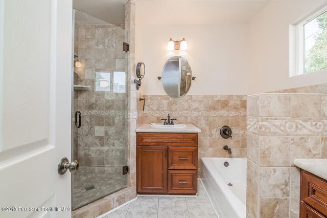 a bathroom with a double vanity sink a mirror and shower