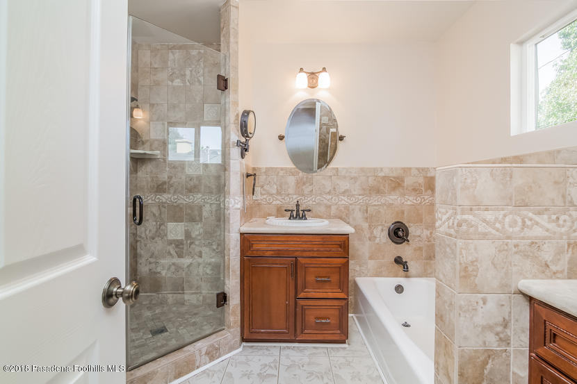 1771 North Altadena Drive Altadena, CA 91001 - Photo 14 of 29 a bathroom with a double vanity sink a mirror and shower