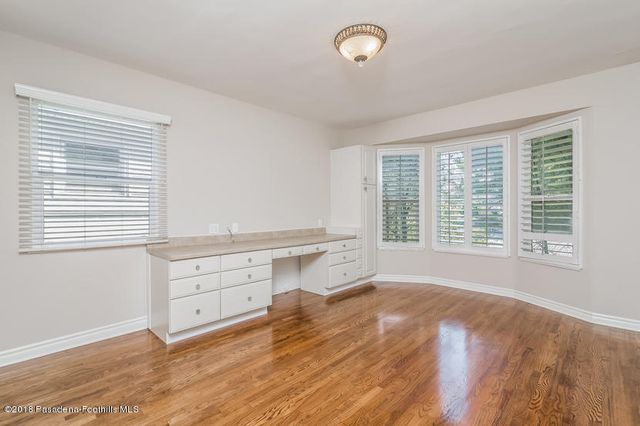 a room with a window and a dresser