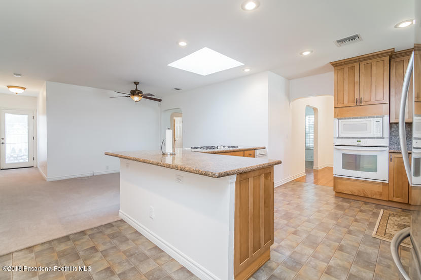 1771 North Altadena Drive Altadena, CA 91001 - Photo 9 of 29 a kitchen with stainless steel appliances granite countertop a sink and a refrigerator