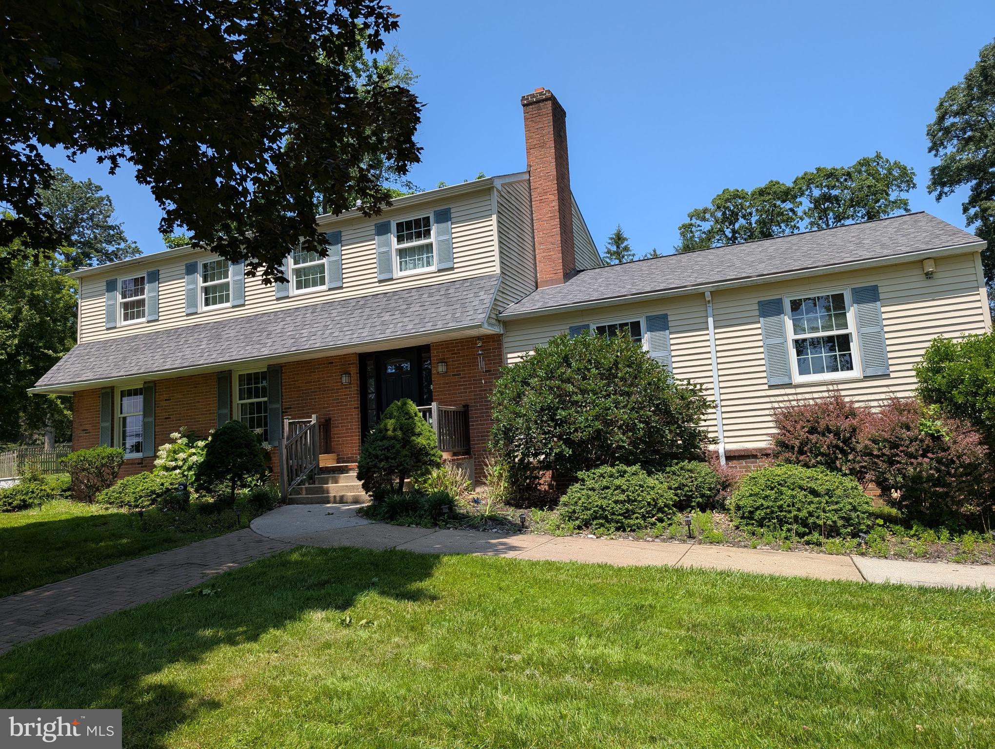 a front view of a house with a yard and potted plants