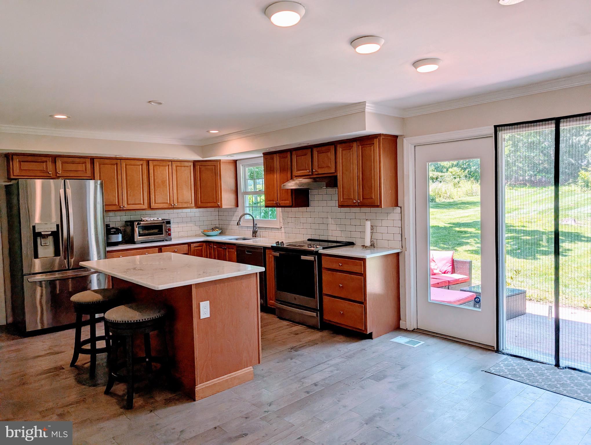 2601 Wayland Road Berwyn, PA 19312 - Photo 6 of 8 a kitchen with stainless steel appliances granite countertop a stove a sink dishwasher a refrigerator and a oven with wooden floor