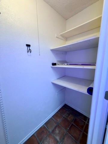 5045 Thunder Road Dallas, TX 75244 - Photo 19 of 28 a view of storage and utility room with racks on the wall