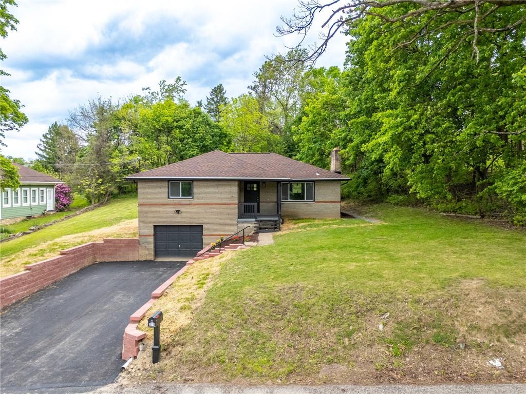 271 Forest Grove Road Coraopolis, PA 15108 - Photo 33 of 40 a front view of a house with garden