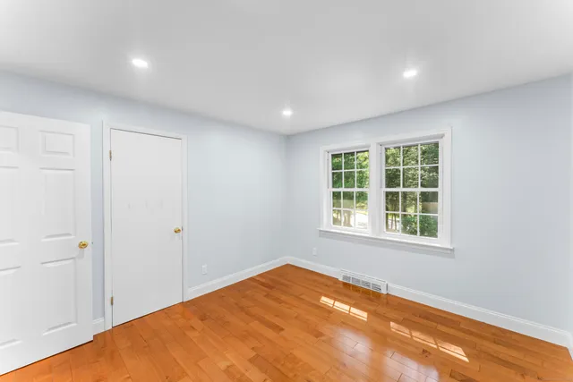 a view of a room that has a bed and a window