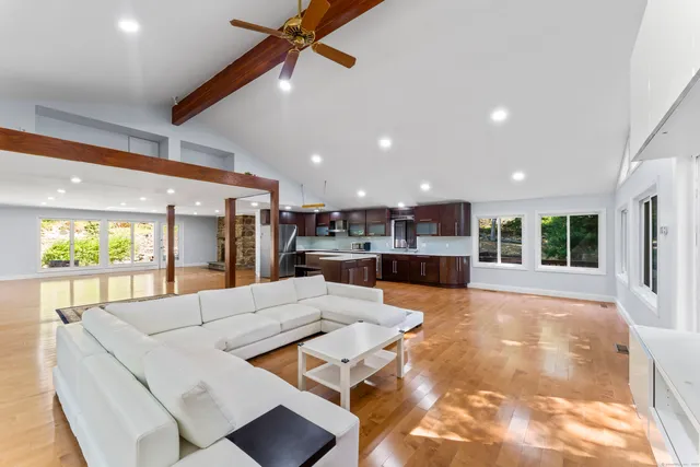 a large kitchen with stainless steel appliances kitchen island granite countertop a large counter top and a stove