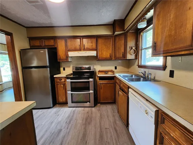 a kitchen with a refrigerator sink and stove