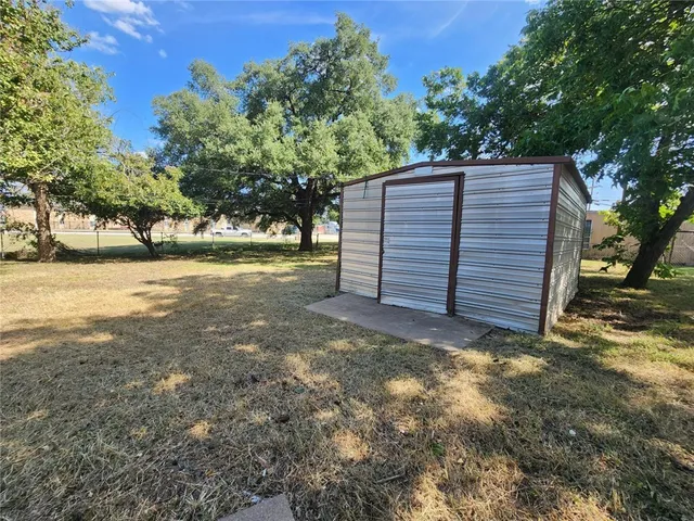 a backyard of a house with shaded area