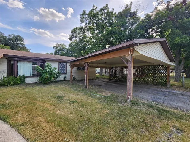 a view of a house with a yard and plants