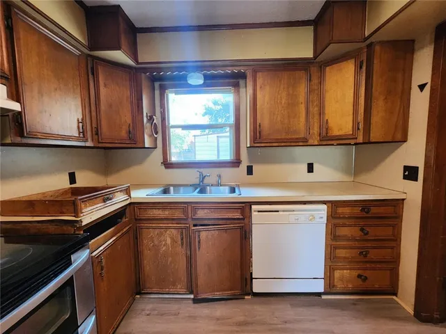 a kitchen with a sink stove and cabinets