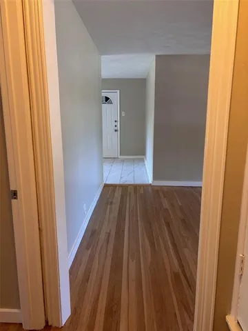 a view of a room with wooden floor