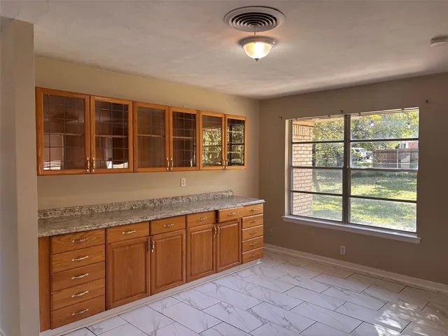 a kitchen with sink cabinets and window