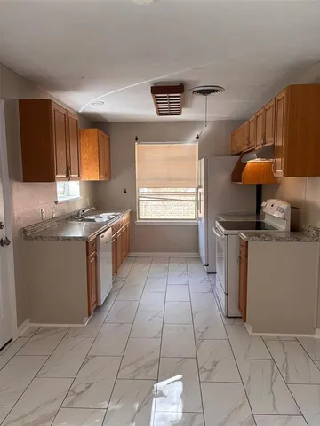a kitchen with a refrigerator and a sink