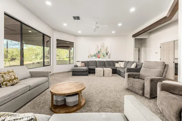 a living room with furniture and a large window