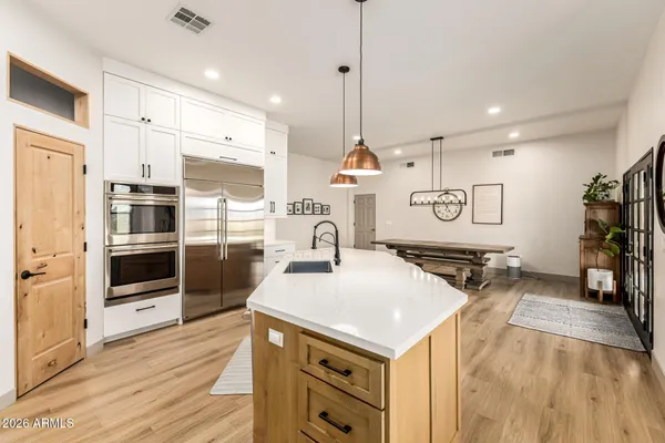 a kitchen with a sink appliances and cabinets