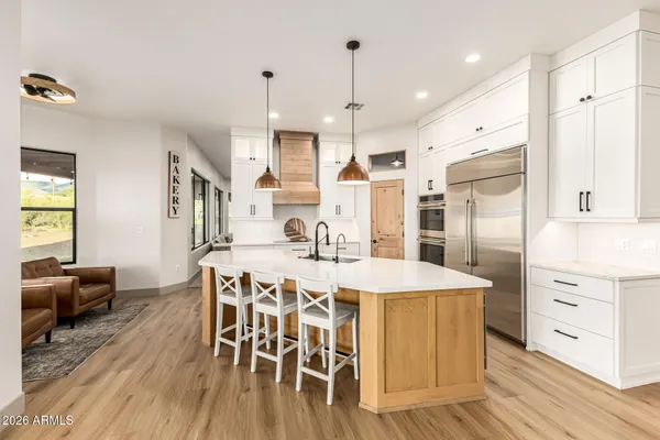 a large kitchen with a table and chairs