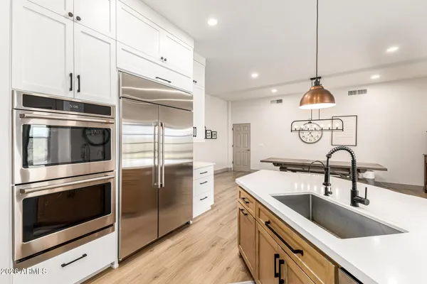 a kitchen with a sink stainless steel appliances and cabinets