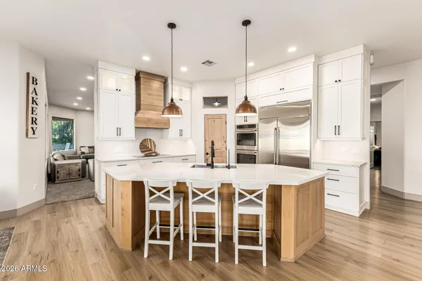 a large kitchen with lots of counter space and stainless steel appliances