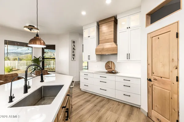 a kitchen with a sink stove and cabinets