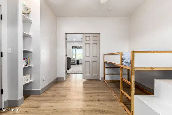 a view of a hallway with wooden floor and staircase