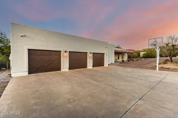 a very nice looking house with a yard and garage