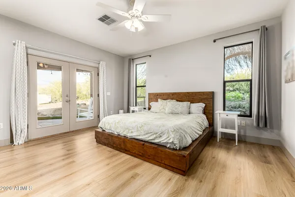 a bedroom with a large bed and a large window
