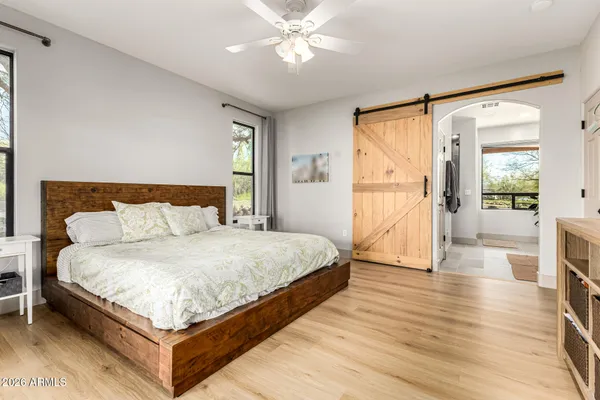 a bedroom with a large bed and a chandelier