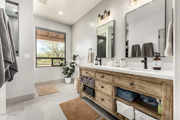 a bathroom with a sink double vanity and a mirror