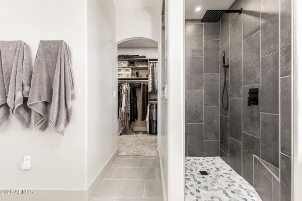 a bathroom with a shower and a sink
