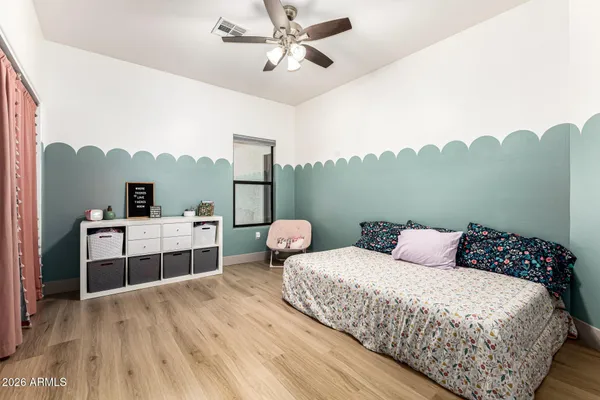 a bedroom with a bed and a chandelier