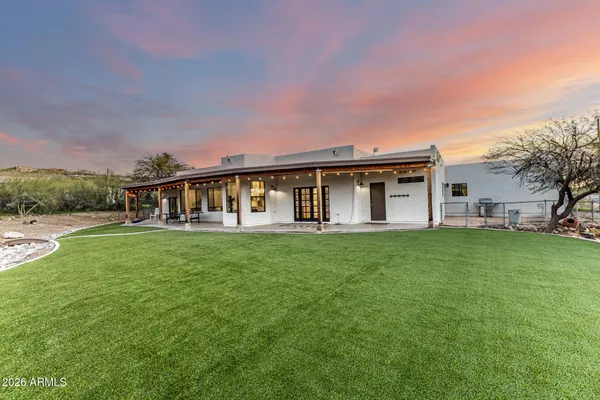 a view of a house with backyard and porch