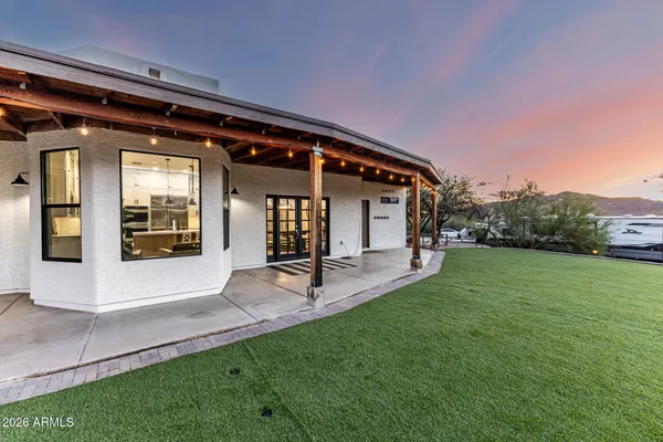 a front view of house with yard and outdoor seating