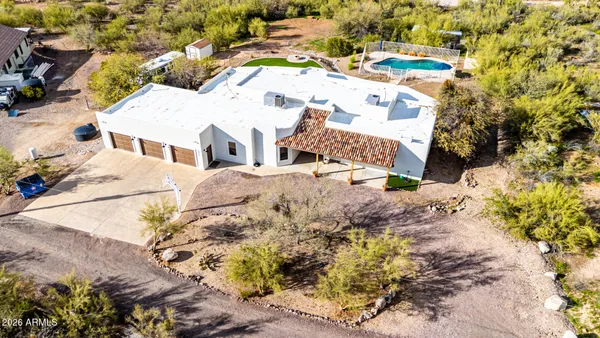 an aerial view of a house with outdoor space