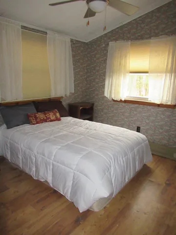 a bedroom with a bed and window