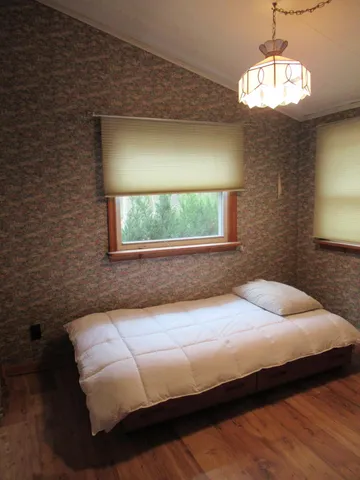 a bedroom with a bed and a window