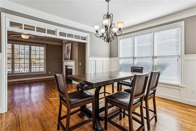 a view of a dining room with furniture wooden floor and chandelier