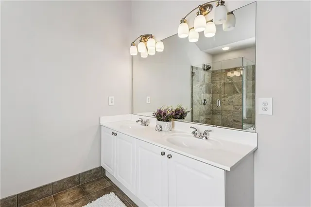 a bathroom with a sink a mirror and a light fixture